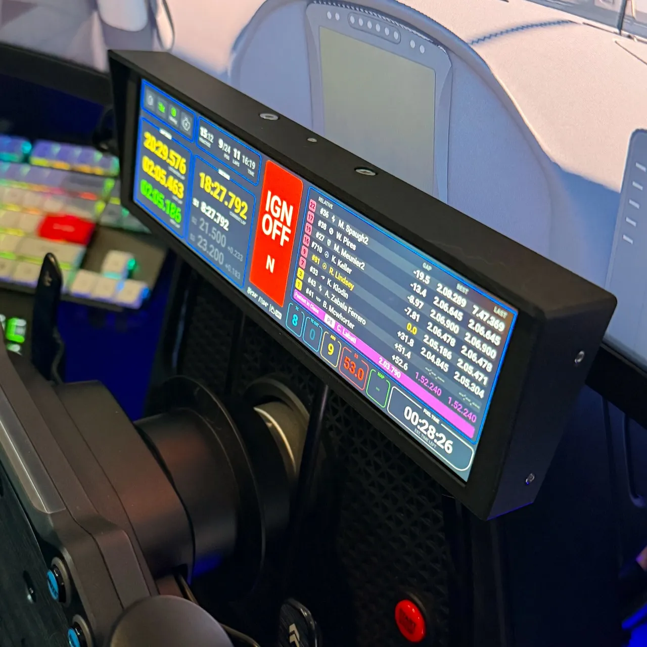 UXL Dashboard PRO mounted in-rig, screen on with live iRacing telemetry — relative timing, lap deltas, ignition state.