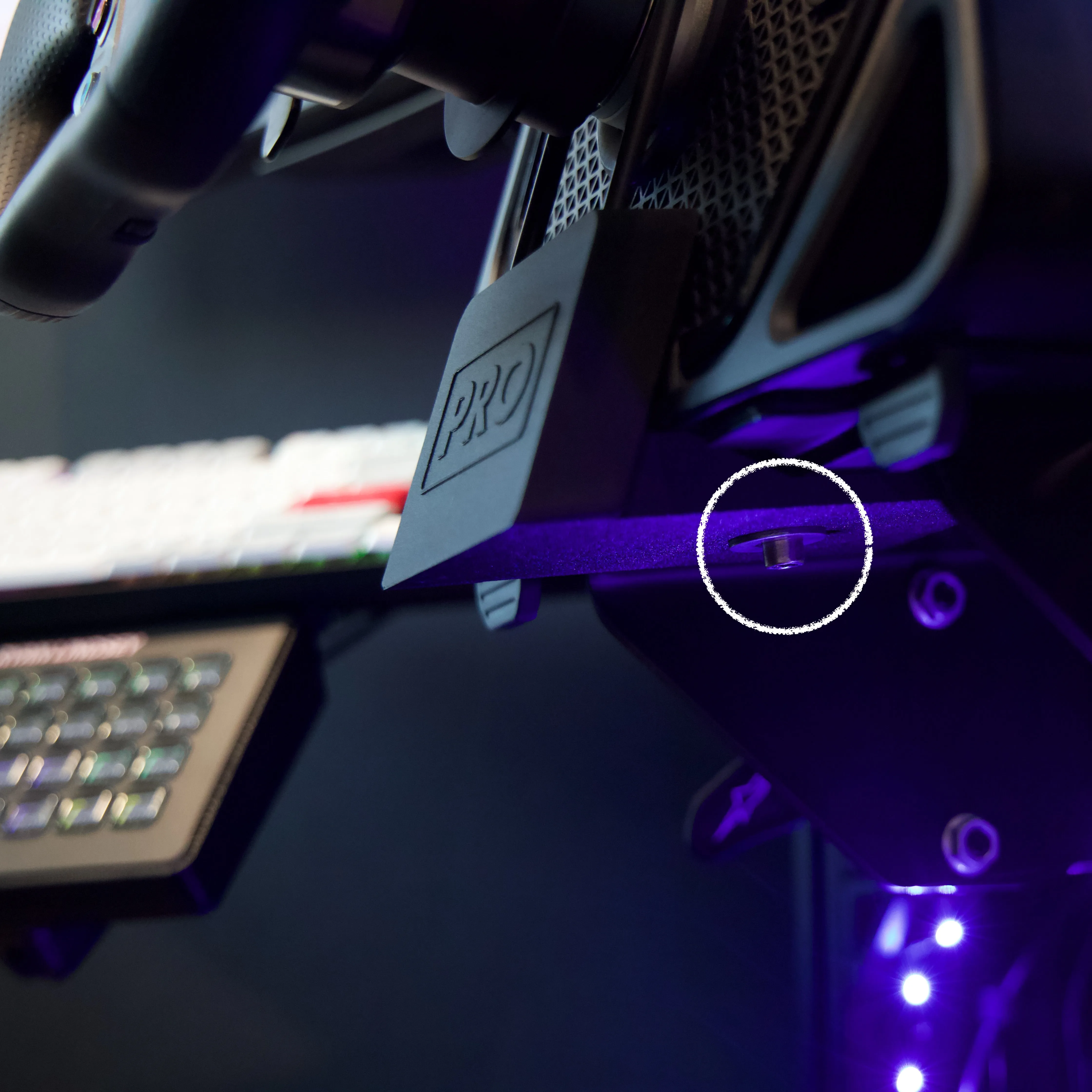 A UXL Dashboard PRO mount fitted to the bottom of a Logitech Pro wheelbase on a sim rig
